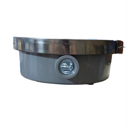 Round metallic object with a central circular component on a white background