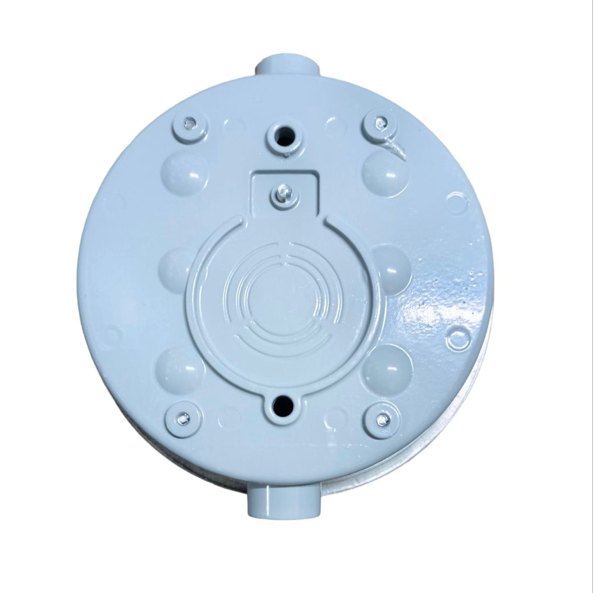 Round metallic object with threaded holes on a white background