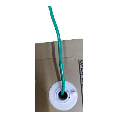 A close-up of a green wire or cord inserted into a white circular plastic spool mounted on a brown cardboard backing against a white background.
