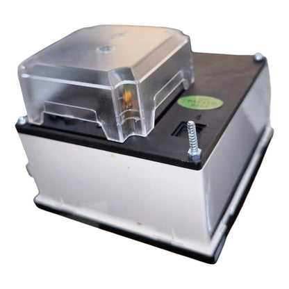 A square electronic component or sensor module with a clear plastic top cover, a black top surface, a silver side panel, and a small green sticker, shown on a white background.