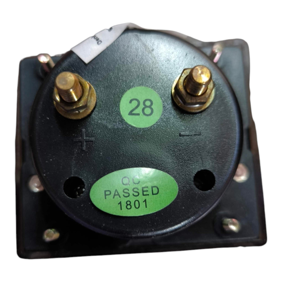 A black circular electrical component with two brass screw terminals, a green sticker with the number 28, and another green sticker reading 'QC PASSED 1801'.