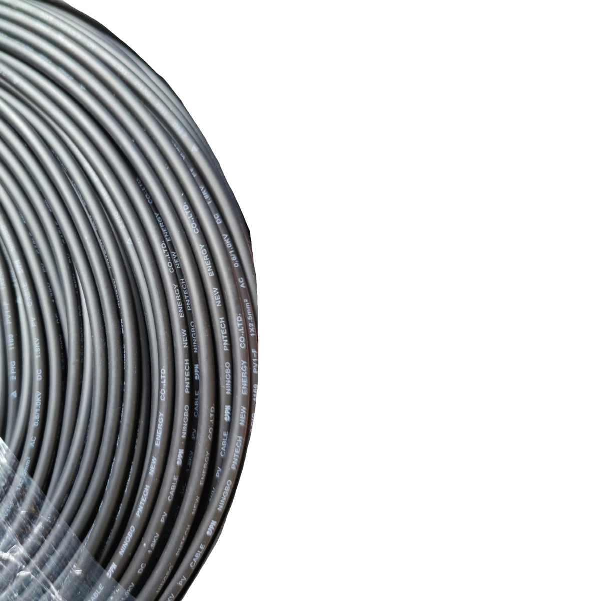 A close-up of a coiled dark gray cable or wire roll wrapped in clear plastic, shown against a plain white background.