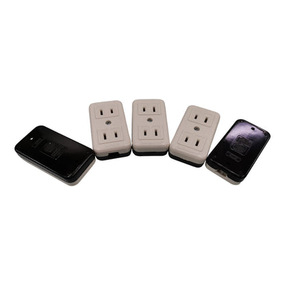 Four electrical outlet covers arranged on a white background, including two black and two beige outlets with protective covers.