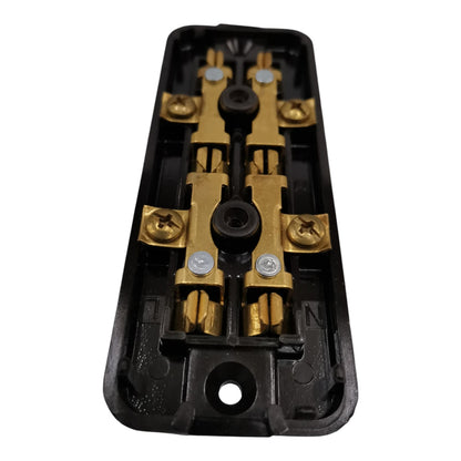 A close-up of a black plastic electrical terminal block with gold-colored metal bus bars and screws, isolated on a white background.