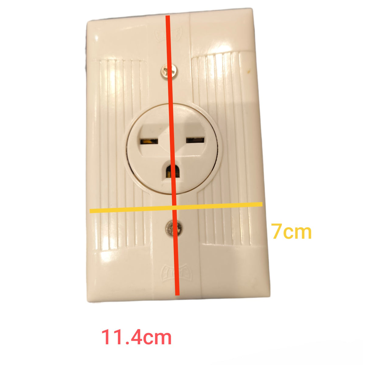A white plastic US electrical outlet shown against a white background with overlaid dimension lines and text indicating 11.4cm width and 7cm height.