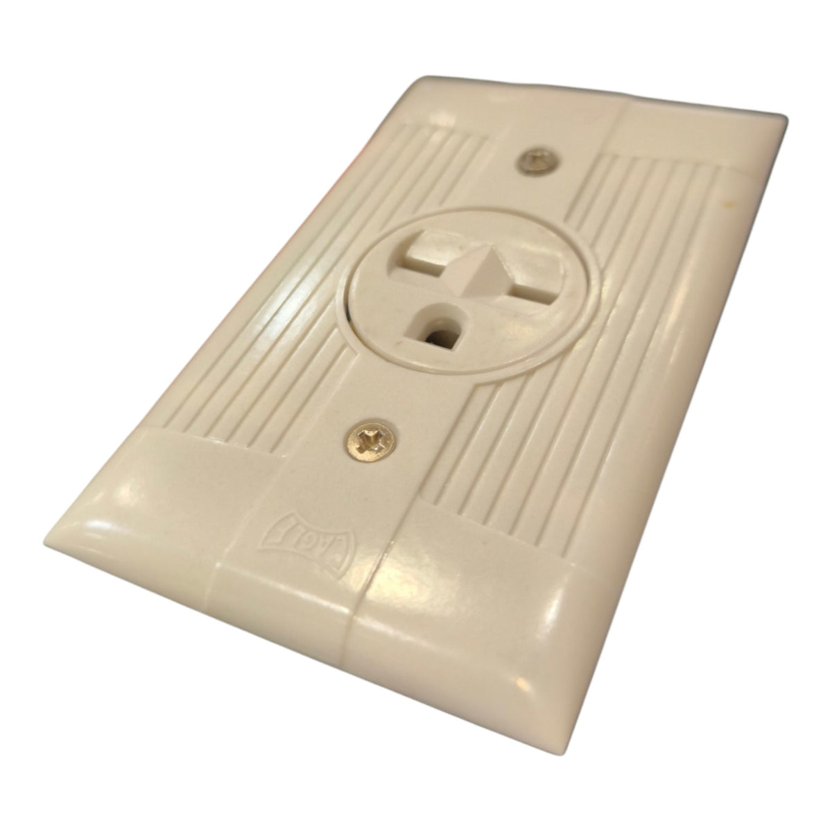 An off-white plastic outlet cover plate with a three-prong electrical socket design, featuring screw holes and ribbed details, shown on a plain white background.