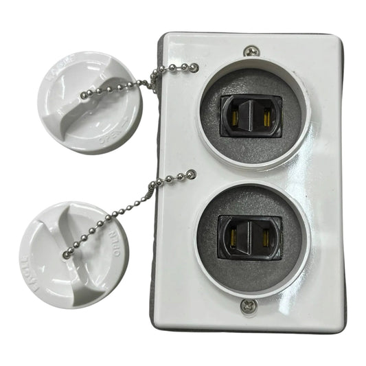 A white plastic dual outlet electrical outlet cover plate with two round outlets and two matching white plastic caps connected by silver ball chains, shown on a white background.