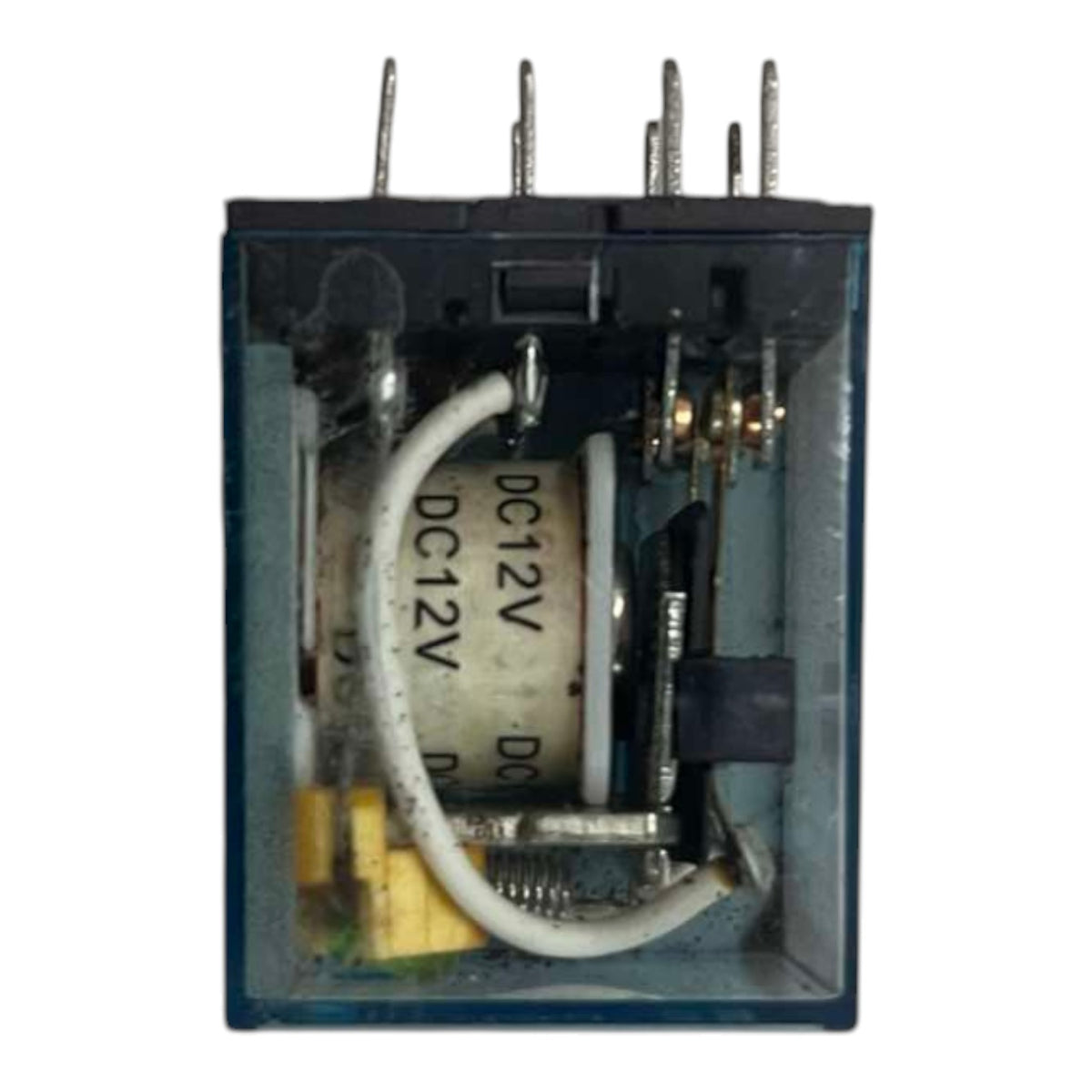 A DC 12V relay transistor shown from the front with its transparent cover removed, revealing internal components including a white cylindrical coil, metal contacts, and a yellow terminal block, set against a plain white background.