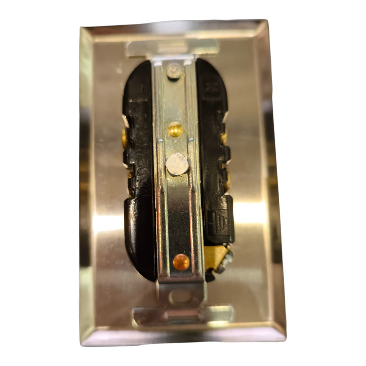 A close-up of a metallic electrical switch component with black and silver parts, set against a plain white background.