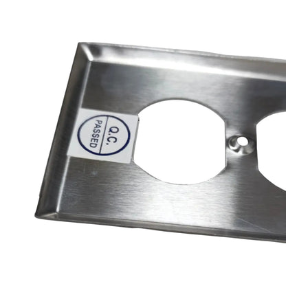 A brushed stainless steel electrical outlet cover plate with two circular cutouts, shown on a white background with a small 'PASSED O.C.