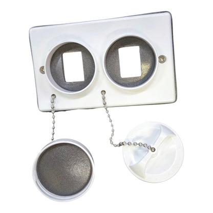 A white plastic dual-sink drain assembly with two circular openings, shown with the lower drain caps and chain detached below on a plain white background.
