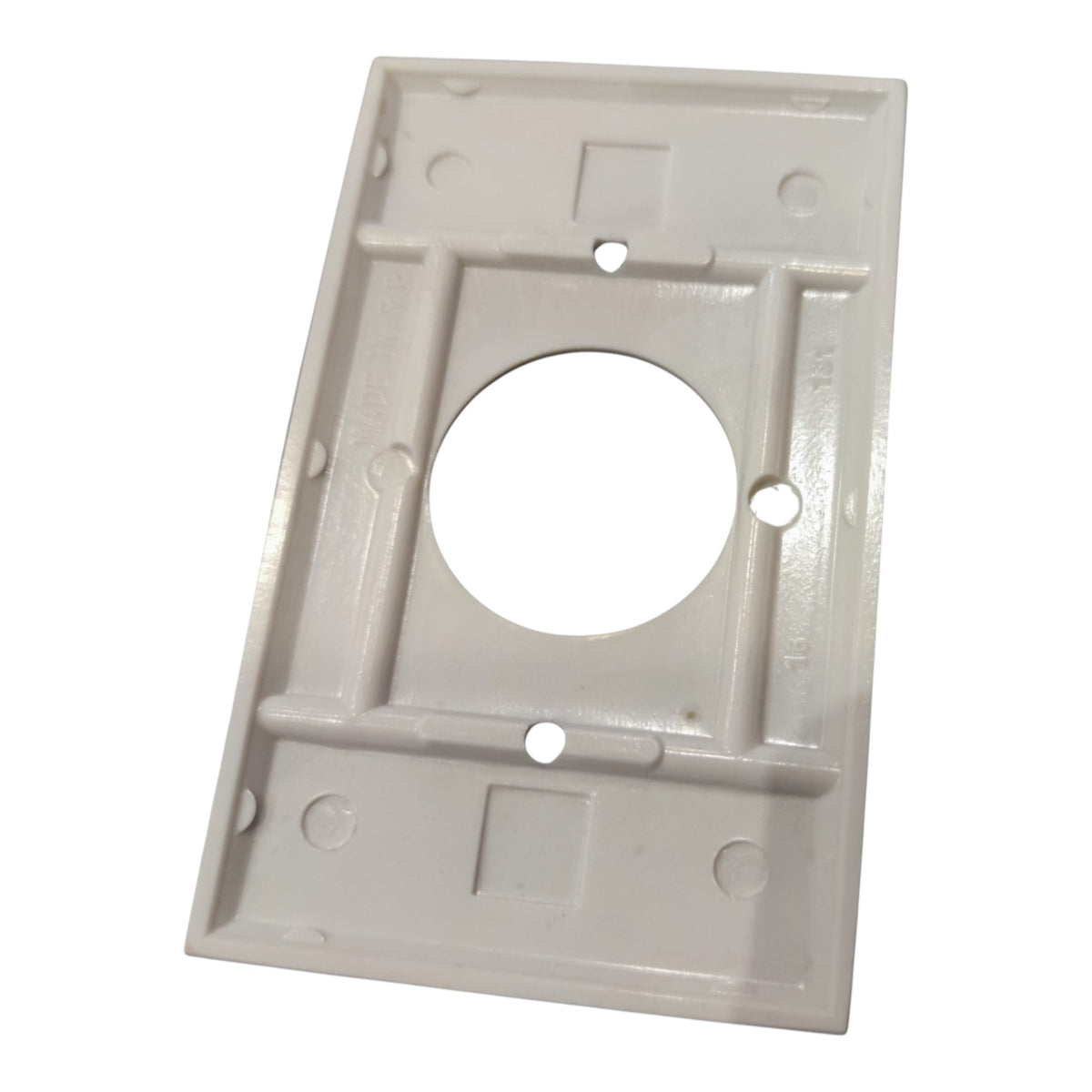 A white plastic rectangular mounting plate or cover with a large circular cutout in the center and several screw holes, shown on a plain white background.