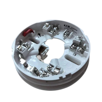 A circular white electrical terminal block with multiple metal screw terminals and a small red wire, isolated on a white background.