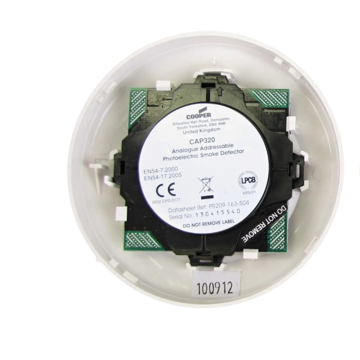 A Cooper CAP320 analogue addressable photoelectric smoke detector inside its white circular mounting base, showing the black and green electronic module with a white product label.