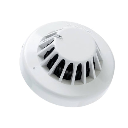 A white round smoke detector with a vented top and a small switch, shown on a plain white background.