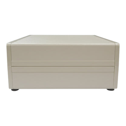 A beige rectangular storage box or drawer unit with a textured top surface and two horizontal front slots, shown against a plain white background.