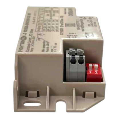 A beige industrial electrical component, specifically a Fritzing LED driver module, with a red terminal connector and gray screw terminals, shown on a white background.
