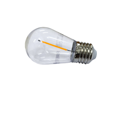 Clear light bulb with visible filament on a white background