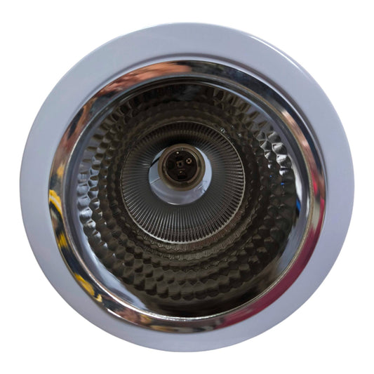 Close-up of a kitchen sink drain with a white rim on a white background