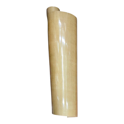 A roll of glossy, light tan adhesive vinyl or contact paper standing vertically on a plain white background.