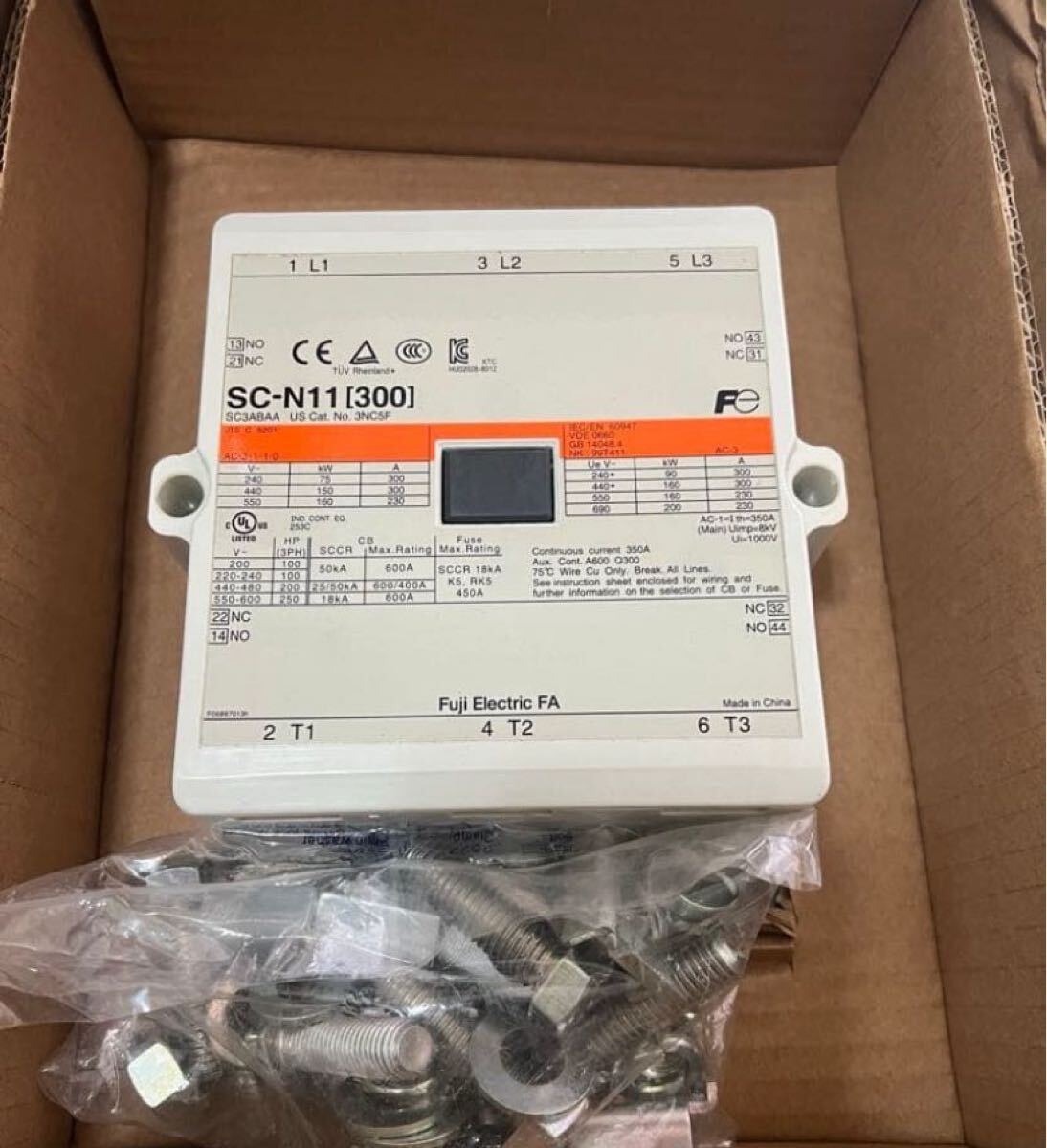 A Fuli Electro SC-N1113001 electrical fuse holder box with a digital display screen and mounting screws, shown inside a brown cardboard box.