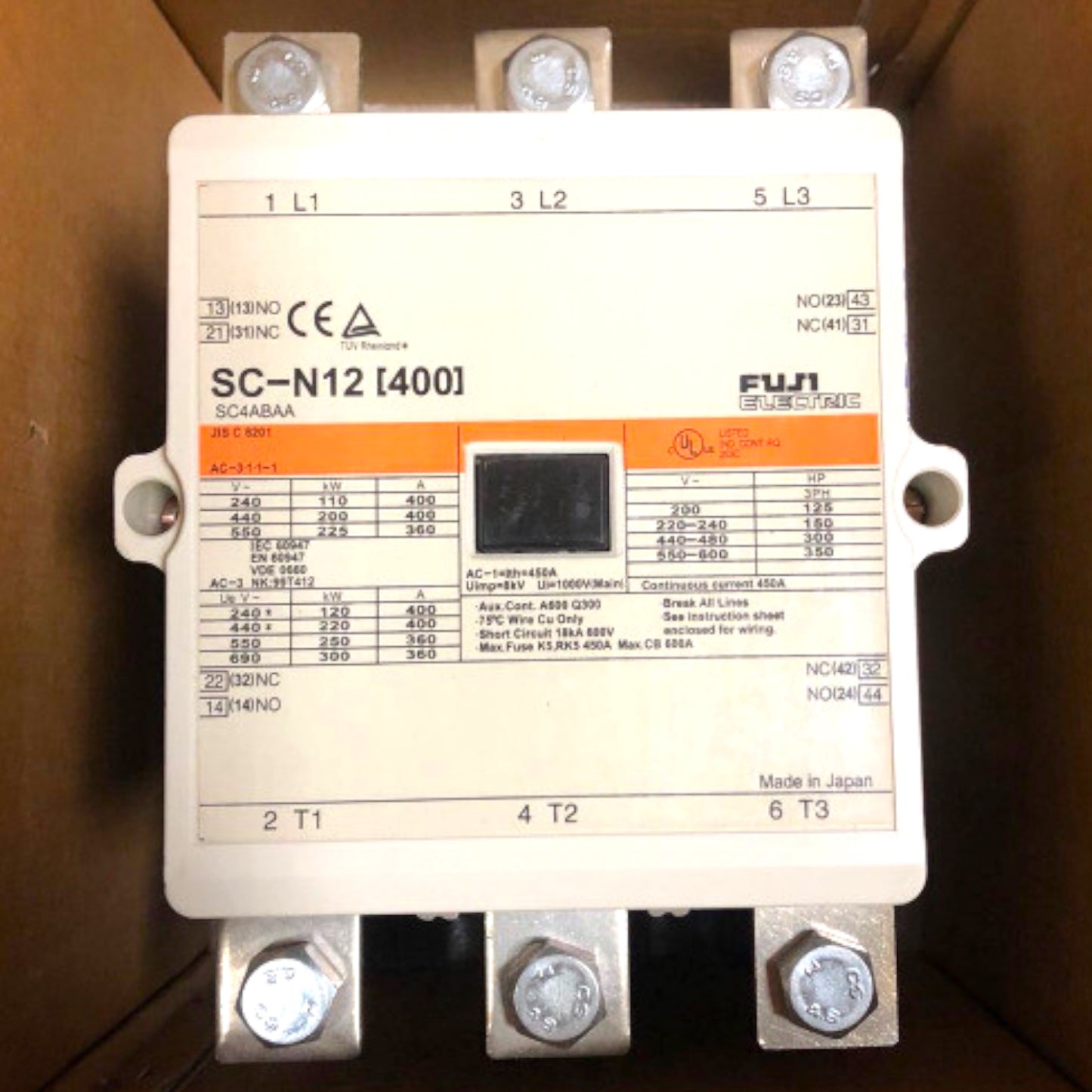 A Fuji Electric SC-N12 I400A industrial electrical contactor terminal block with screw terminals, a central black contact area, and printed technical specifications on a white faceplate, photographed inside a brown cardboard box.