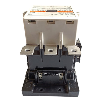 A heavy-duty electrical contactor with a black plastic main body, silver metal terminal blocks, and a beige top cover with printed technical specifications.