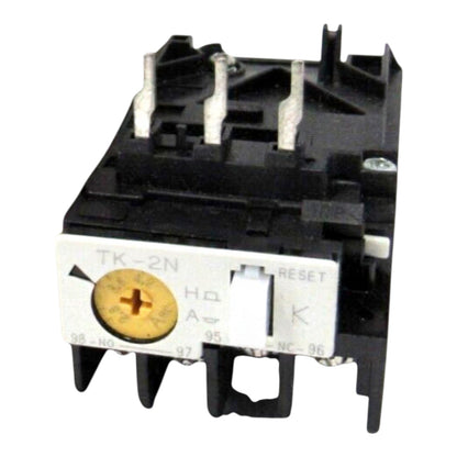 A black plastic thermal overload relay, model TK-2N, with a white front terminal cover showing a gold-colored dial and white switch components, isolated on a white background.