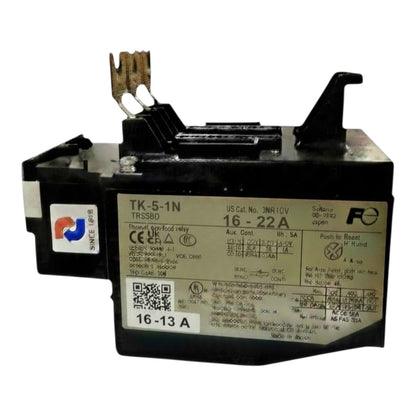 A black industrial electrical relay component with a beige label showing technical specifications and a push-in terminal connector on top, photographed on a white background.