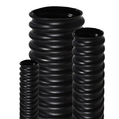 Three black ribbed flexible plastic tubes of different heights, arranged on a plain white background.