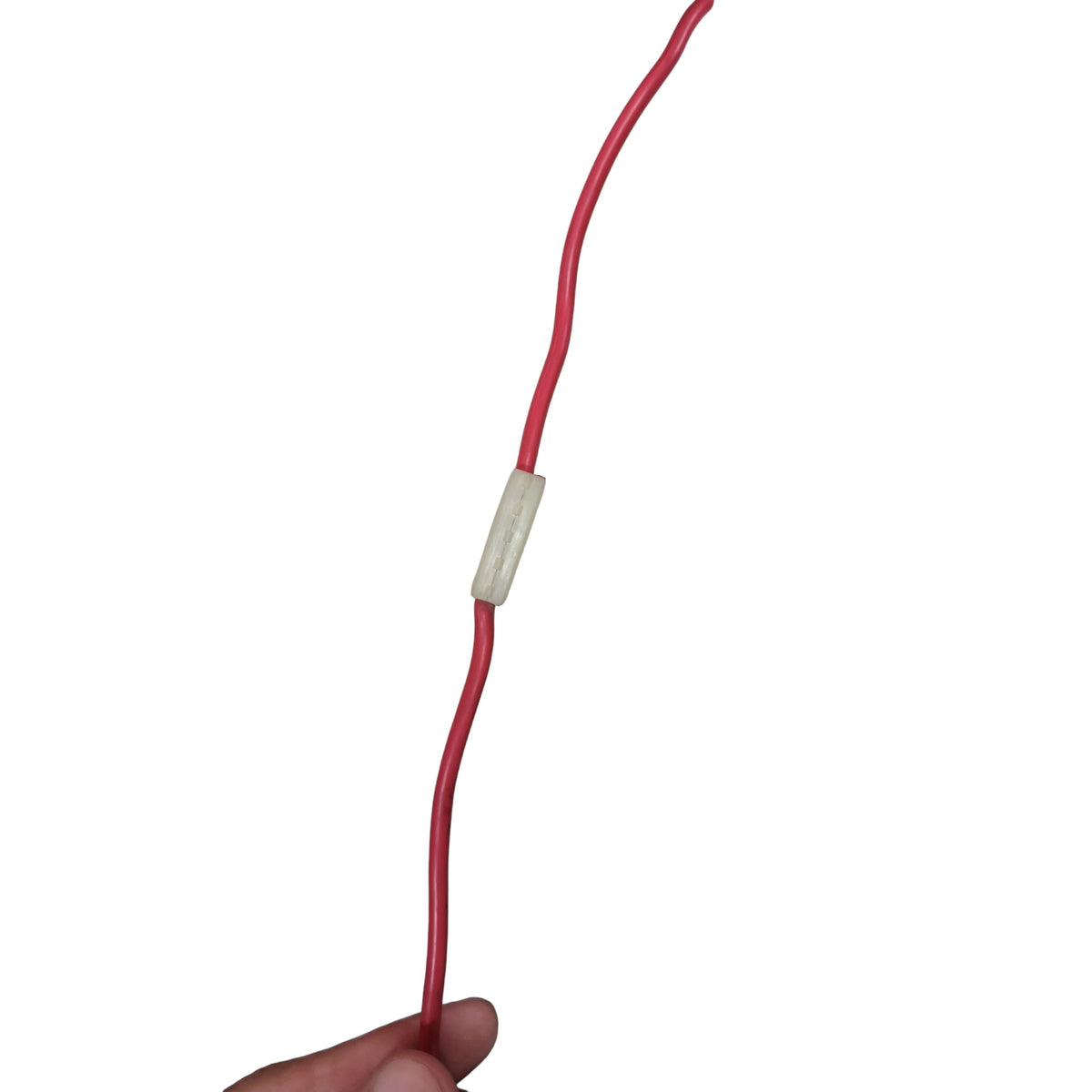 A red cable with a small beige rectangular inline connector, held by a hand against a plain white background.