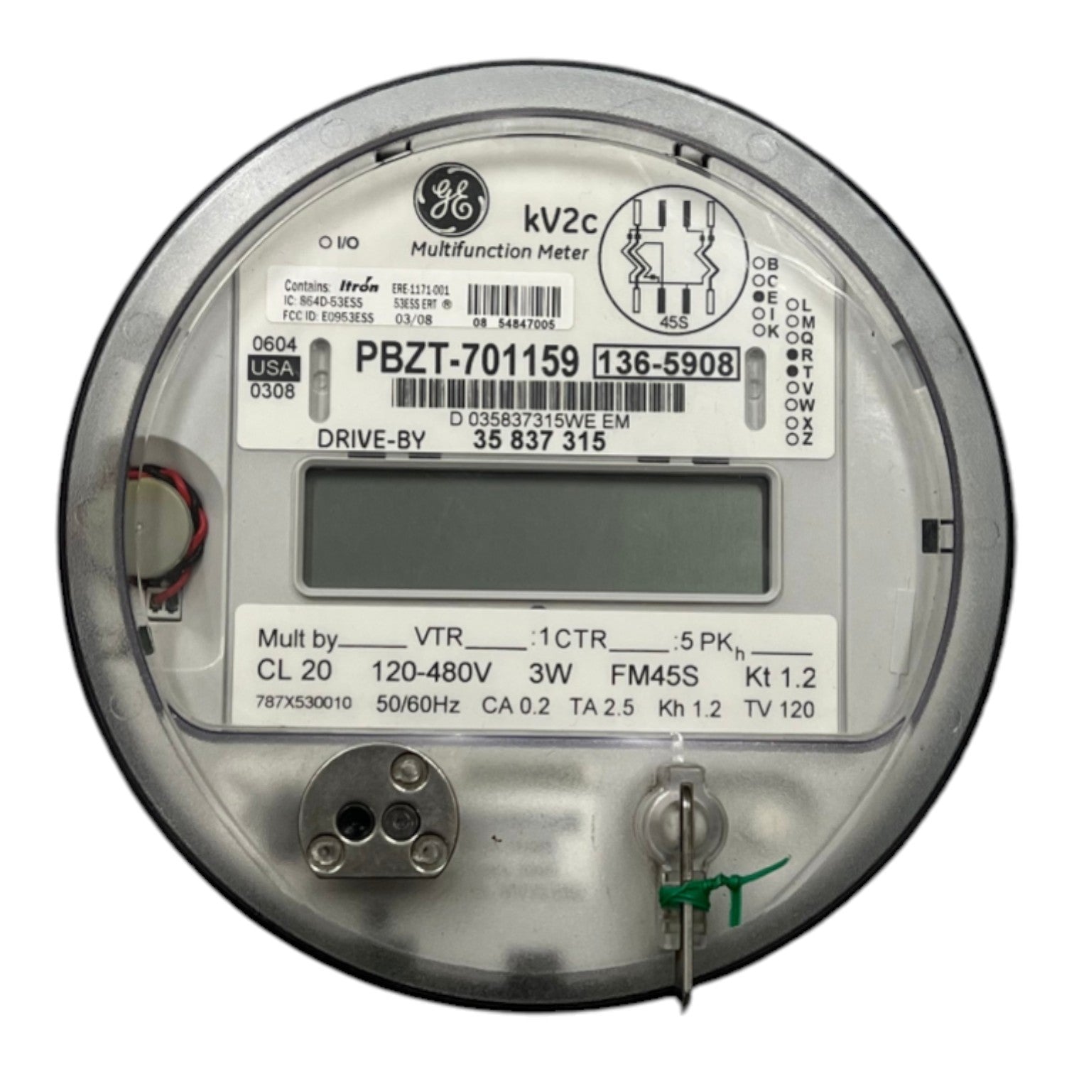A round GE multifunction electricity meter with a digital display screen, technical specifications printed on the label, and metal terminals on a white background.