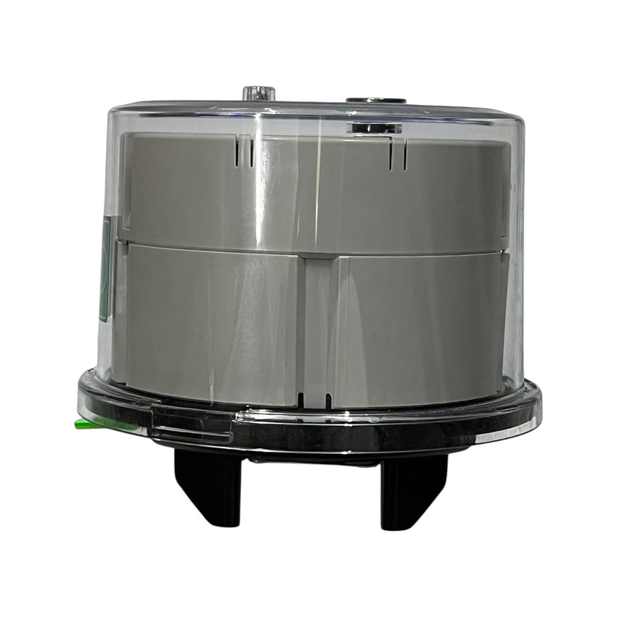Round metallic object with transparent top on a white background