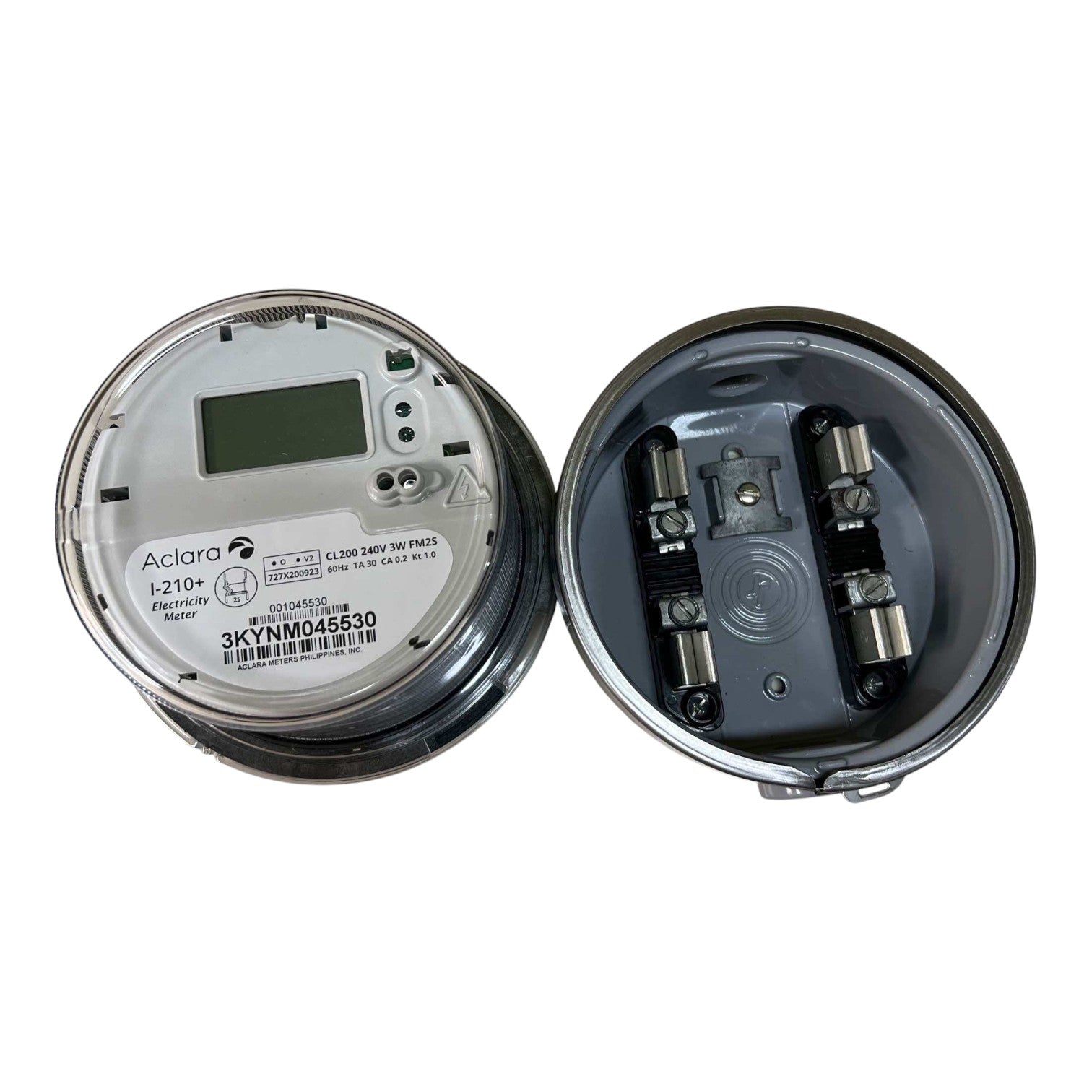 An open circular electrical meter showing the inside components, photographed on a plain white background. The left side shows the dial face with a small display and printed model text, and the right side shows the internal metal contacts and housing.