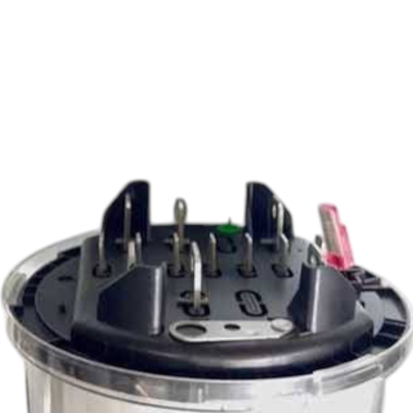 A close-up of a circular black electrical terminal block or connector with multiple metal pins and a small pink wire, set against a plain white background.