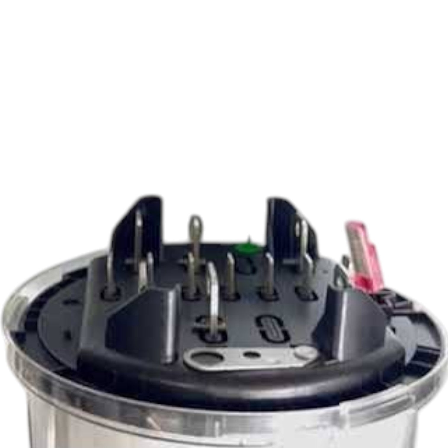 A close-up of a circular black electrical terminal block or connector with multiple metal pins and a small pink wire, set against a plain white background.