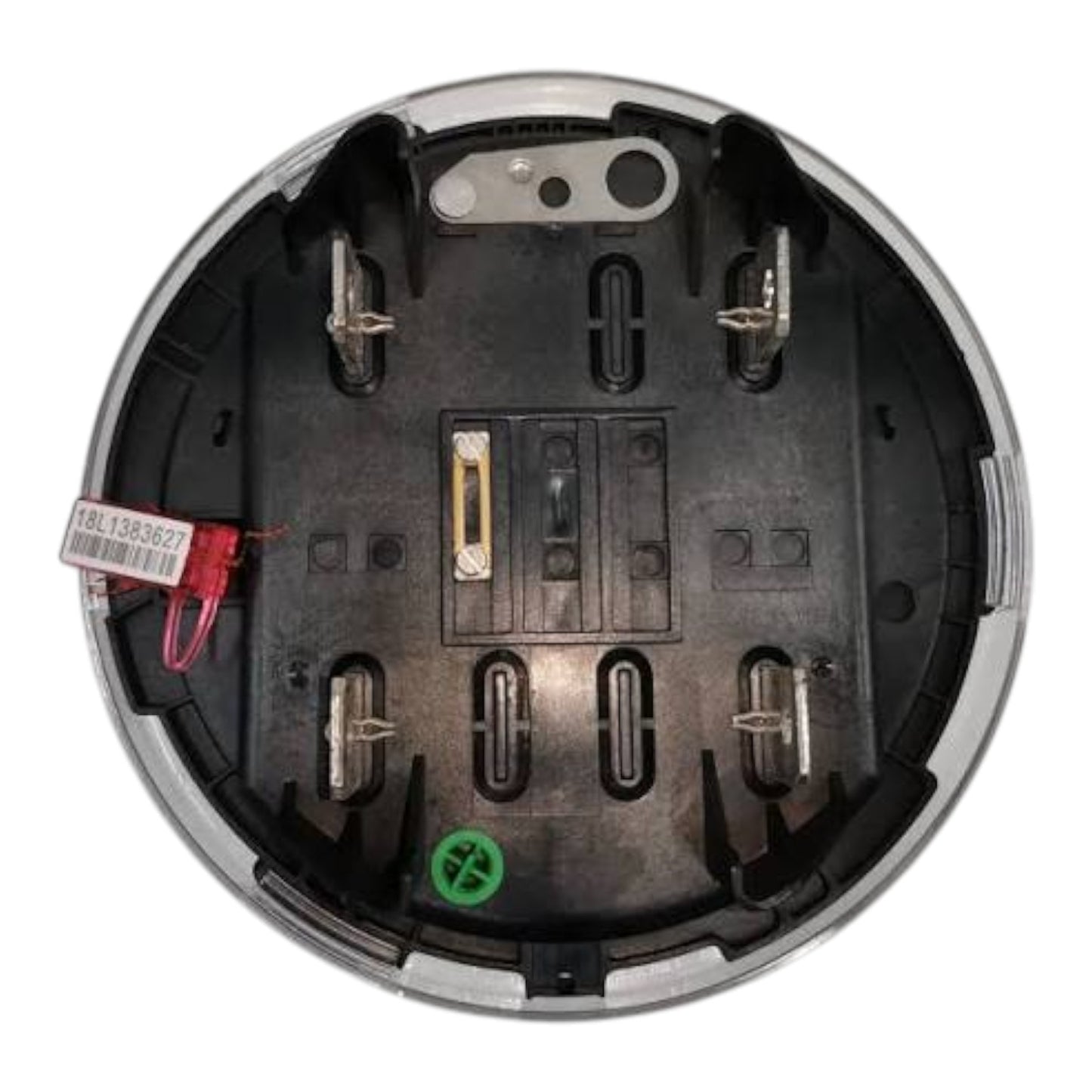 Top-down view of a circular black electrical compartment or battery terminal housing with metal terminals, a small red wire with a white tag, and a green plastic insert near the bottom, isolated on a white background.