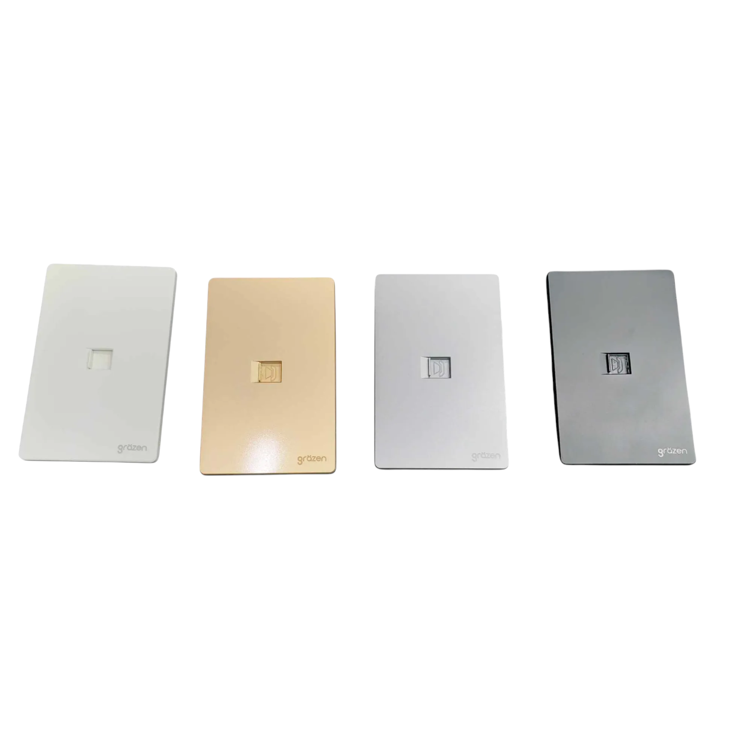 Four rectangular wall outlets in different finishes lined up horizontally on a white background: white, champagne gold, silver, and dark gray. Each outlet has a small square cutout in the center and the brand name 'g&g' printed at the bottom left.