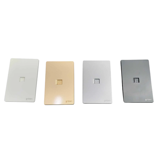 Four rectangular wall outlets in different finishes lined up horizontally on a white background: white, champagne gold, silver, and dark gray. Each outlet has a small square cutout in the center and the brand name 'g&g' printed at the bottom left.