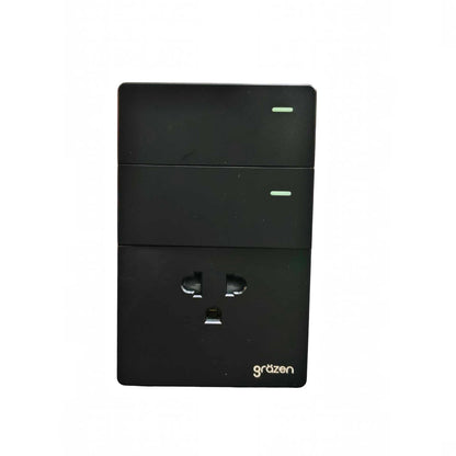 A black 3-AU plug adapter with three stacked rectangular sections, featuring a UK three-pin socket on the bottom half and small green indicator lights on the top two sections. The brand name 'gräzen' is printed in white near the bottom right corner.