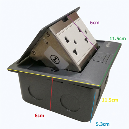 A black electrical outlet cover with a partially flipped-up socket faceplate, shown with overlaid dimension labels including 6cm, 11.5cm, 11.