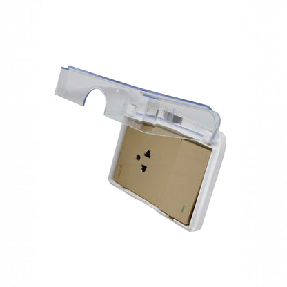 A wall outlet cover with a transparent clear plastic lid and a white plastic base, showing a beige backplate inside. The lid is shown in an open position, angled upwards.