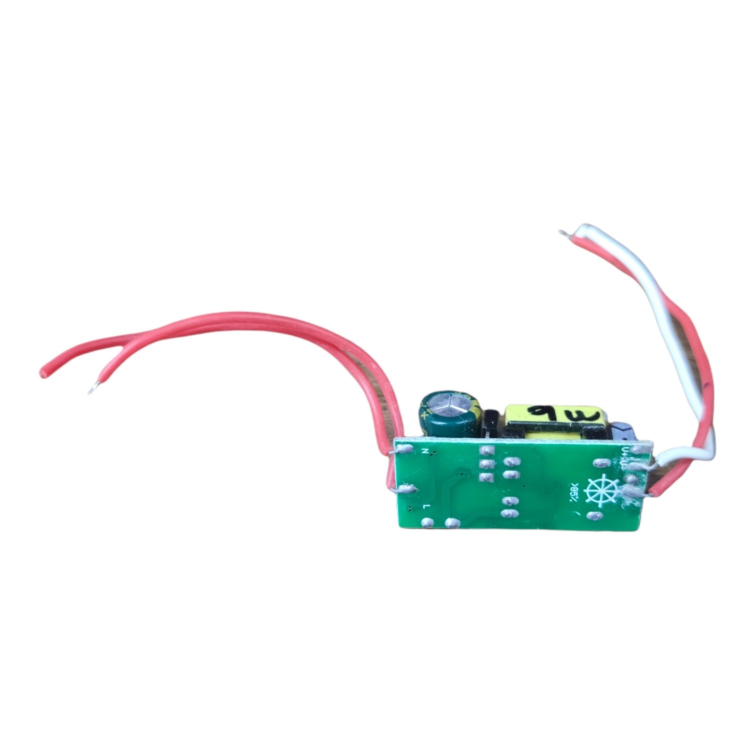A small electronic circuit board module with a green PCB, featuring red and white wires, a black cylindrical component, and a yellow cylindrical component, shown on a plain white background.