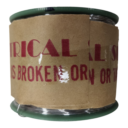 A spool of wire with a brown cardboard label wrapped around it, featuring red printed text and dark green plastic ends, shown on a white background.