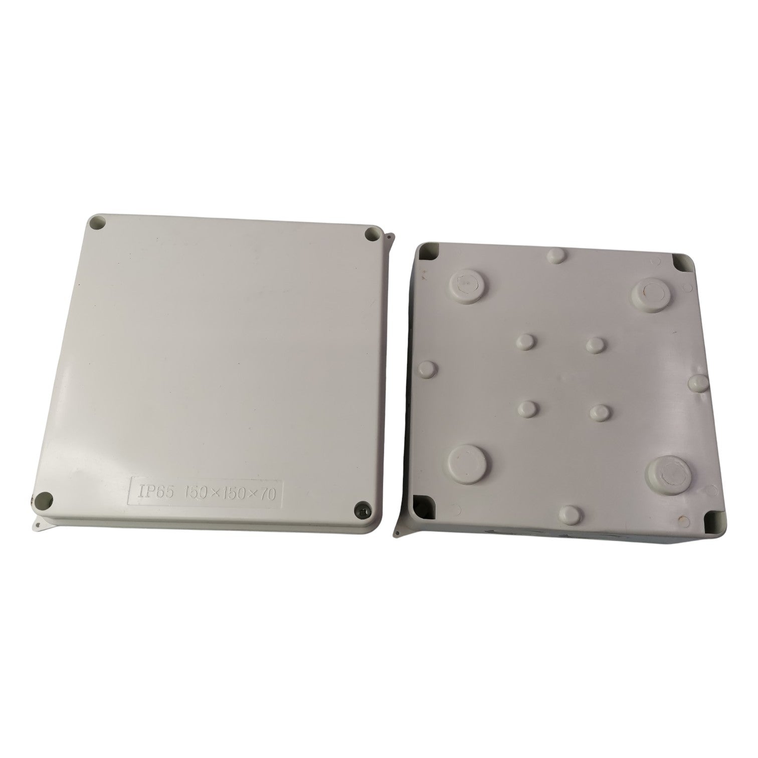 Two gray plastic enclosures with textured surface on a white background
