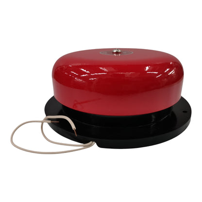 A red dome-shaped alarm or signal device mounted on a black circular base with a beige wire leading away, photographed on a plain white background.