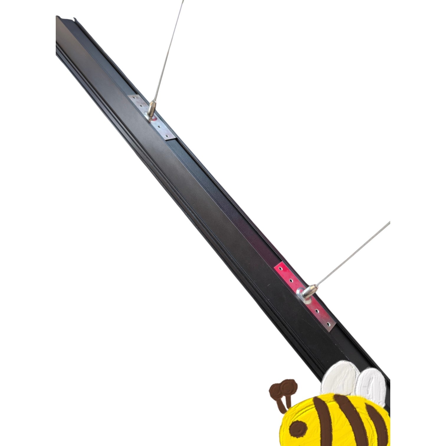 A long black metal rod or bracket with two thin wire-like rods attached at intervals, shown on a plain white background. A cartoon bee graphic appears at the bottom right corner.