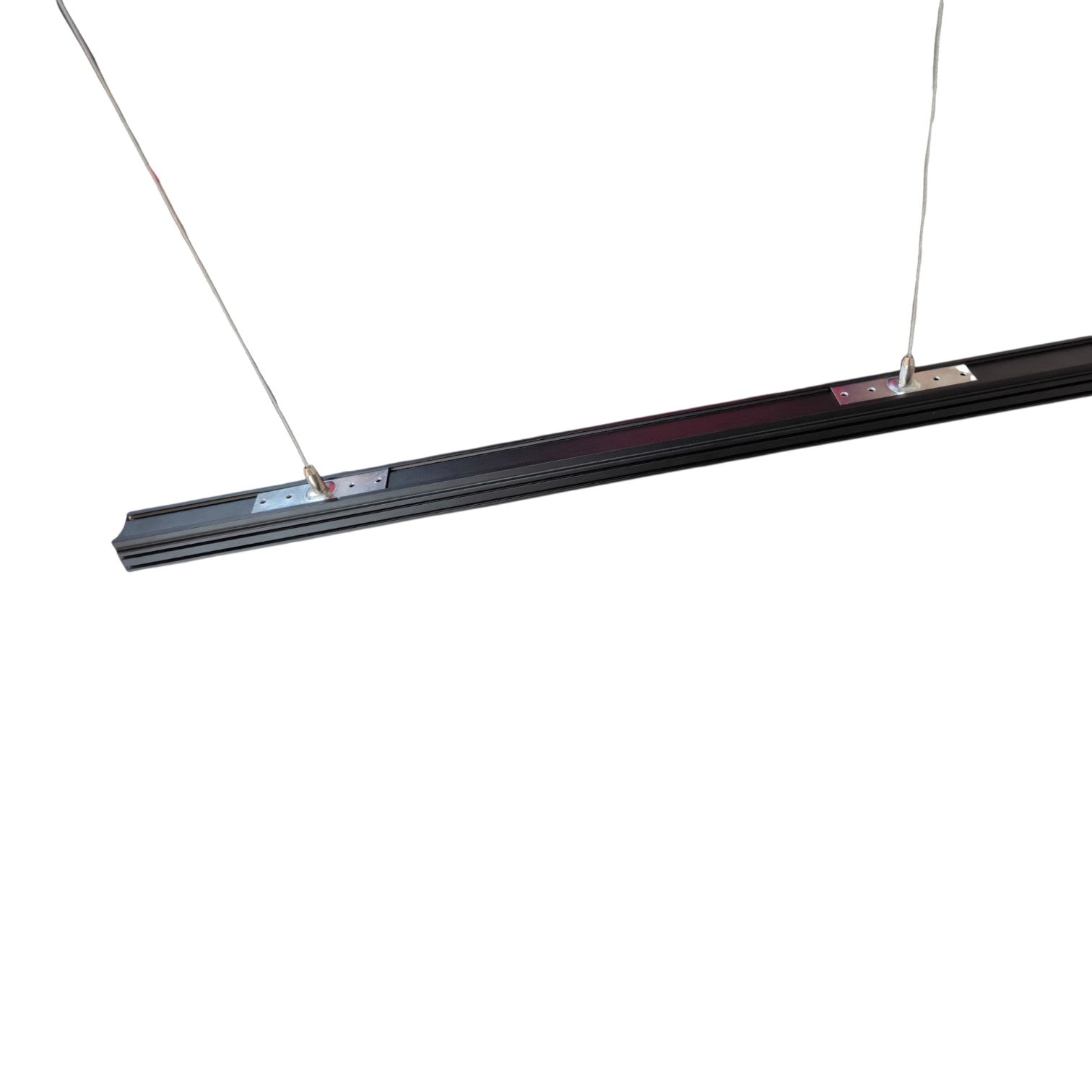A long, slim black linear light fixture suspended by two thin cables against a plain white background.