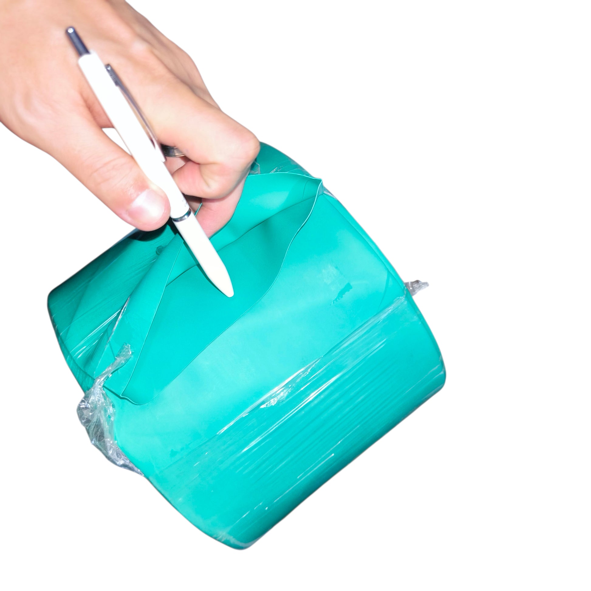 Turquoise inflatable bag with a white pen being used on a white background