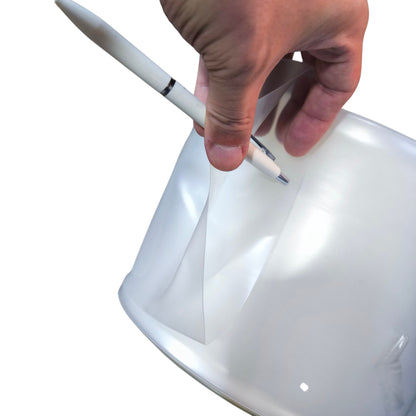 Hand holding a white rod against a white background